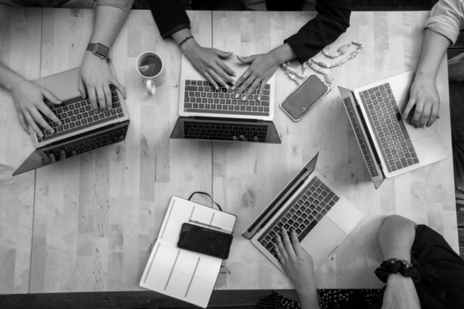 Team collaboration session showing developers working directly with clients on blockchain solutions